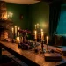 Moody dark cottagecore interior with candlelight, dried roses, and vintage decor for a romantic evening.