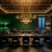 Cinematic moody dining room with emerald green walls, a black oak table, and a large brass chandelier.