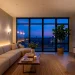 Wide view of a brightened rental living room using layered lighting hacks to eliminate dark corners.