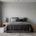 Sophisticated grey bedroom with layered textures, charcoal linens, and natural light in a 2:1 wide shot.