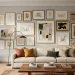 A wide shot of a professional gallery wall in a modern living room with a cream sofa and oak floors.