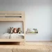 Wide shot of a luxury Scandinavian shared kids bedroom with a minimalist birch wood bunk bed.