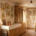 Wide panoramic view of a sun-drenched vintage laundry room with a farmhouse sink and rustic wooden elements.