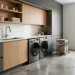 Wide view of a modern laundry room with sleek charcoal and oak cabinets and integrated smart appliances.