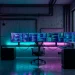 Futuristic cyberpunk home office with neon RGB lighting and dark industrial metal furniture.