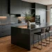 Sophisticated modern kitchen featuring matte charcoal cabinetry, a central island, and warm wood flooring.