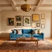 Wide shot of a vibrant eclectic living room with bold wallpaper, velvet furniture, and mixed patterns.