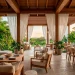 Luxurious covered patio with flowing white linen curtains and teak furniture for a relaxing spa atmosphere.