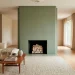 Wide shot of a luxury living room featuring a sophisticated sage green fireplace and modern decor.