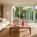 Wide shot of a minimalist living room with a walnut tapered-leg coffee table and cream linen sofa.
