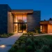 Modern home exterior featuring a beautiful combination of dark slate stone and warm cedar wood siding.