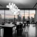 Modern monochrome dining room with black oak table and sculptural white lighting.