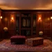 Luxurious dark academia dressing room with mahogany wardrobes and warm vintage lighting.