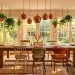 Wide shot of a boho dining room featuring reclaimed wood, jute rugs, velvet chairs, and hanging plants.