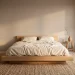 Wide panoramic view of a minimalist Japandi bedroom with low wooden bed and warm neutral tones.