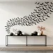 Modern minimalist entryway with chic black and white Halloween decorations and paper bat wall art.