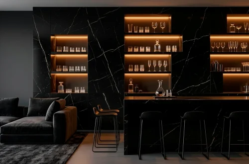 Luxurious wide-angle view of a modern monochromatic home bar with charcoal marble and designer bar stools.