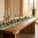 Luxurious Easter dining room with sage green velvet table runner and eggs on an oak table.