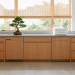 Zen laundry room organization with minimalist oak cabinets and peaceful morning light in a calm home.