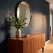 Modern apartment entry with navy and gold geometric renter-friendly wallpaper and walnut console table.