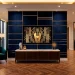 Luxurious Art Deco living room featuring a navy velvet and gold brass TV wall with high-end furniture.