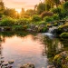 A serene natural backyard pond with a stone waterfall, lush plants, and clear reflecting water.