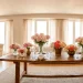 Luxurious Mother's Day interior featuring multiple professional peony floral arrangements on a wooden table.