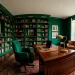 Luxury home office with emerald green walls, dark wood desk, and brass accents in professional photography.