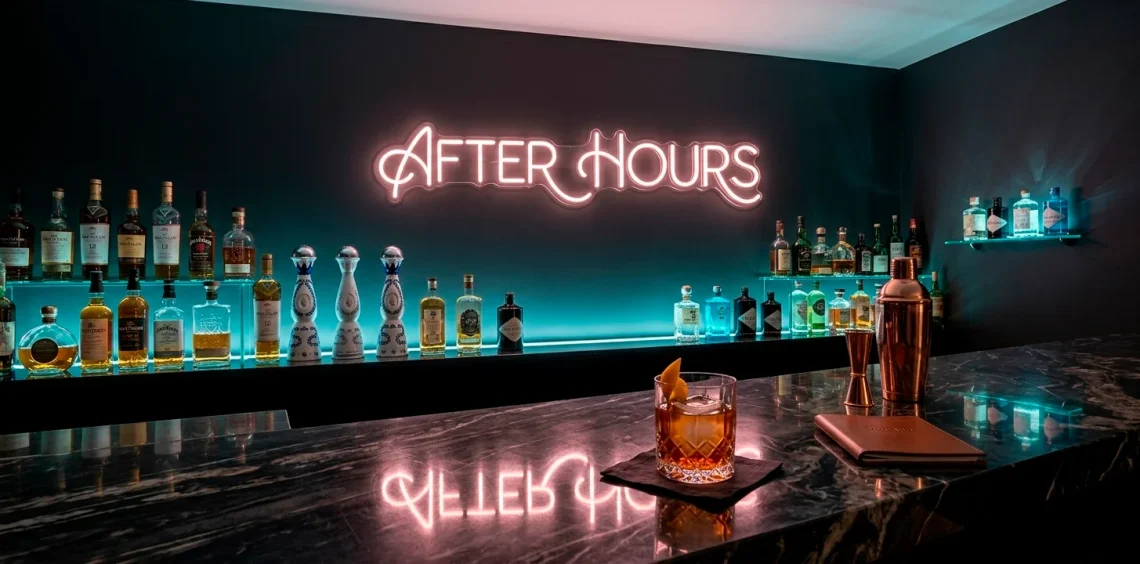 Luxury home bar with moody neon lighting and dark charcoal walls for a nightclub atmosphere.