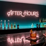 Luxury home bar with moody neon lighting and dark charcoal walls for a nightclub atmosphere.