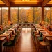 Luxurious autumn wedding reception with emerald velvet runners and warm golden candle lighting.