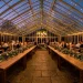 Wide view of a serene wedding reception with sage green velvet runners and eucalyptus greenery.