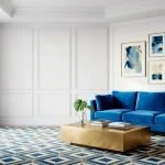 Small modern living room with vibrant electric blue velvet sofa and gold accents in a bright space.