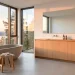 Wide shot of a bright and airy Scandinavian bathroom layout with natural wood and stone textures.
