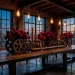 Moody industrial loft dining room with matte black steel table and deep red roses in metal vases.