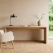 Wide horizontal view of a serene Japandi home office with light wood desk and natural sunlight.