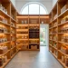 Luxurious modern walk-in pantry with sustainable bamboo shelving and organized glass jars in a bright kitchen.