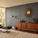 Luxurious mid-century modern living room with iconic furniture and moody charcoal walls.