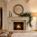 Beautifully balanced fireplace mantle decor ideas featuring a gold mirror, black candlesticks, and eucalyptus garland.