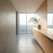 Wide horizontal view of a perfectly clean minimalist bathroom featuring seamless hidden storage cabinets.