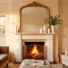 A wide horizontal view of an ornate gold Victorian mirror styled elegantly above a living room fireplace mantel