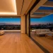 Luxurious modern living room seamlessly transitioning into an elegant outdoor balcony space at dusk with cohesive furniture.