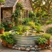 A beautiful DIY stock tank pond surrounded by lush plants and river rocks in a cozy backyard setting during golden hour.