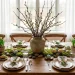 Sustainable Easter tablescape with moss runner, foraged branches, and linen napkins on a wooden table.