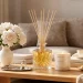 A luxurious Mother's Day gift display featuring high-end home fragrance sets, candles, and diffusers on a living room table.