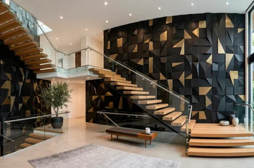 Wide view of modern staircase with black and brass 3D geometric wall tiles