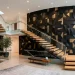 Wide view of modern staircase with black and brass 3D geometric wall tiles