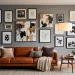Wide horizontal view of a sophisticated living room with a long modular gallery wall and leather sofa.