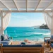 A wide 2:1 landscape of a luxurious white coastal pergola on a seaside deck with navy blue accents.