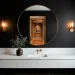 A wide-angle view of a modern luxury black powder room with marble vanity and gold accents.